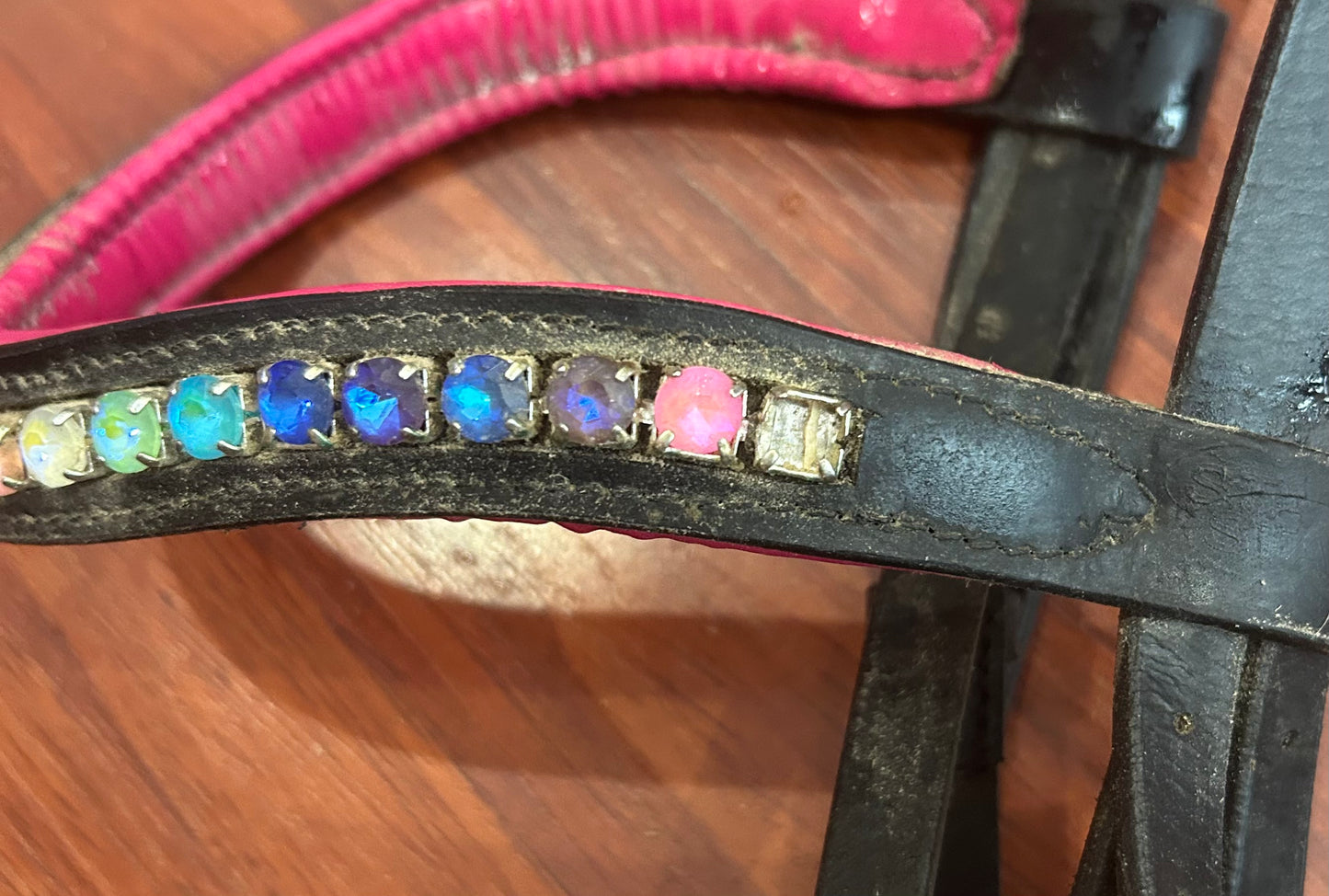Cob size black/pink/rainbow bridle. No flash. Missing one stone