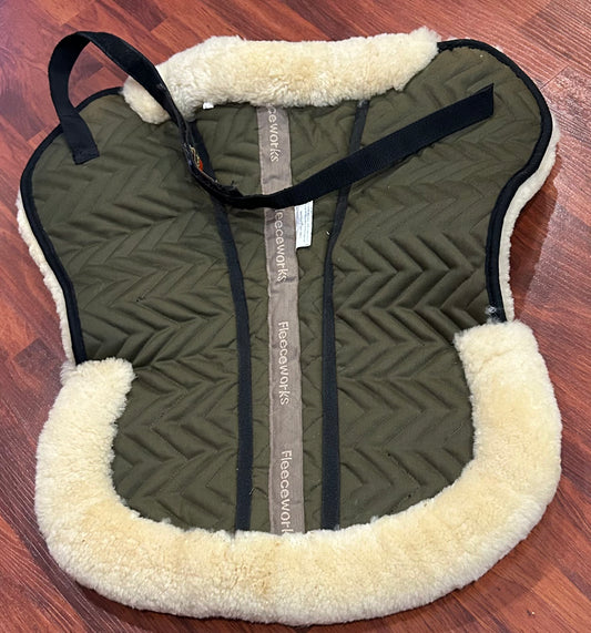 Fleeceworks sheepskin half pad. Saddle area measures 18” along spine. Minor dirt from use.