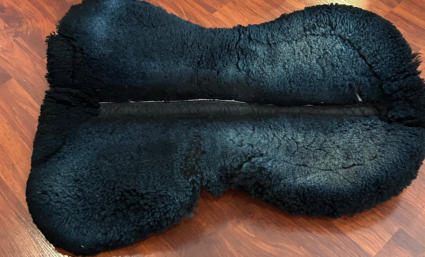 Champion large black half pad. Thick. Sheepskin is discoloured but clean