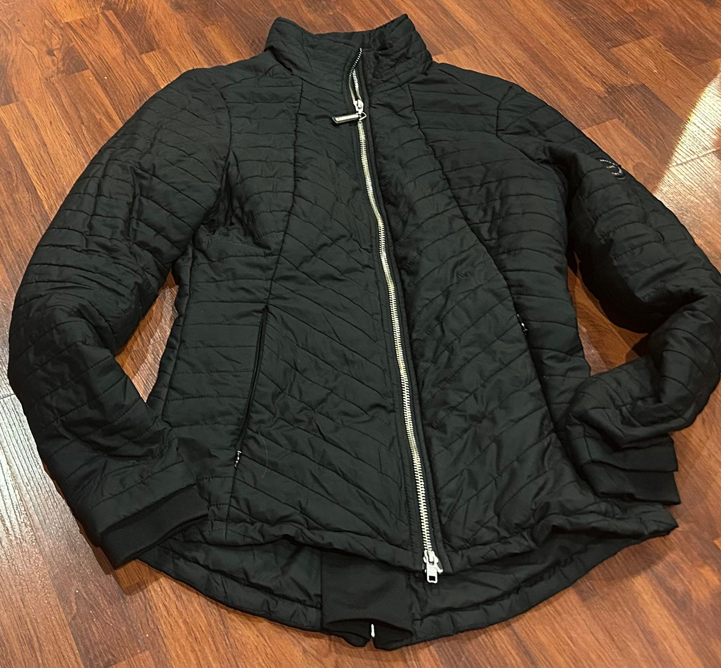 Asmar XS black puffy jacket. Zipper at back for riding.
