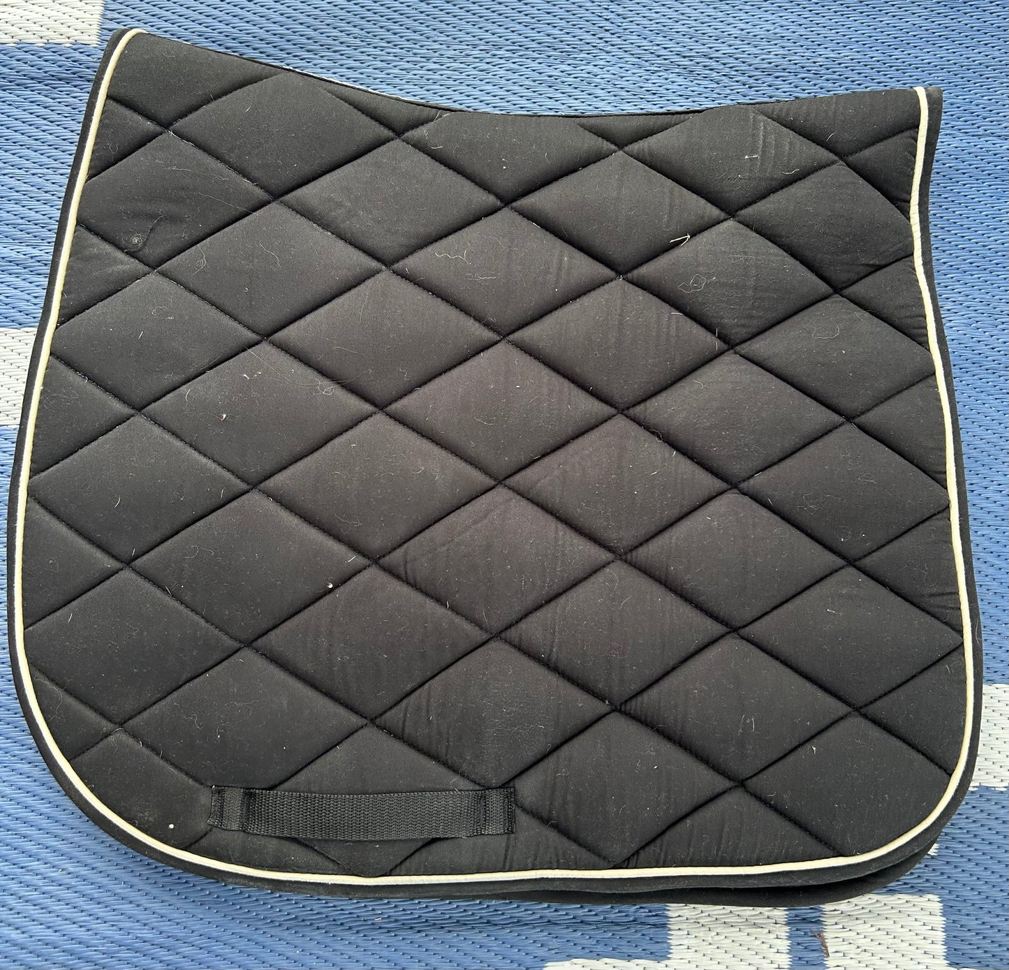 Black with white trim quilted dressage pad. Dirty
