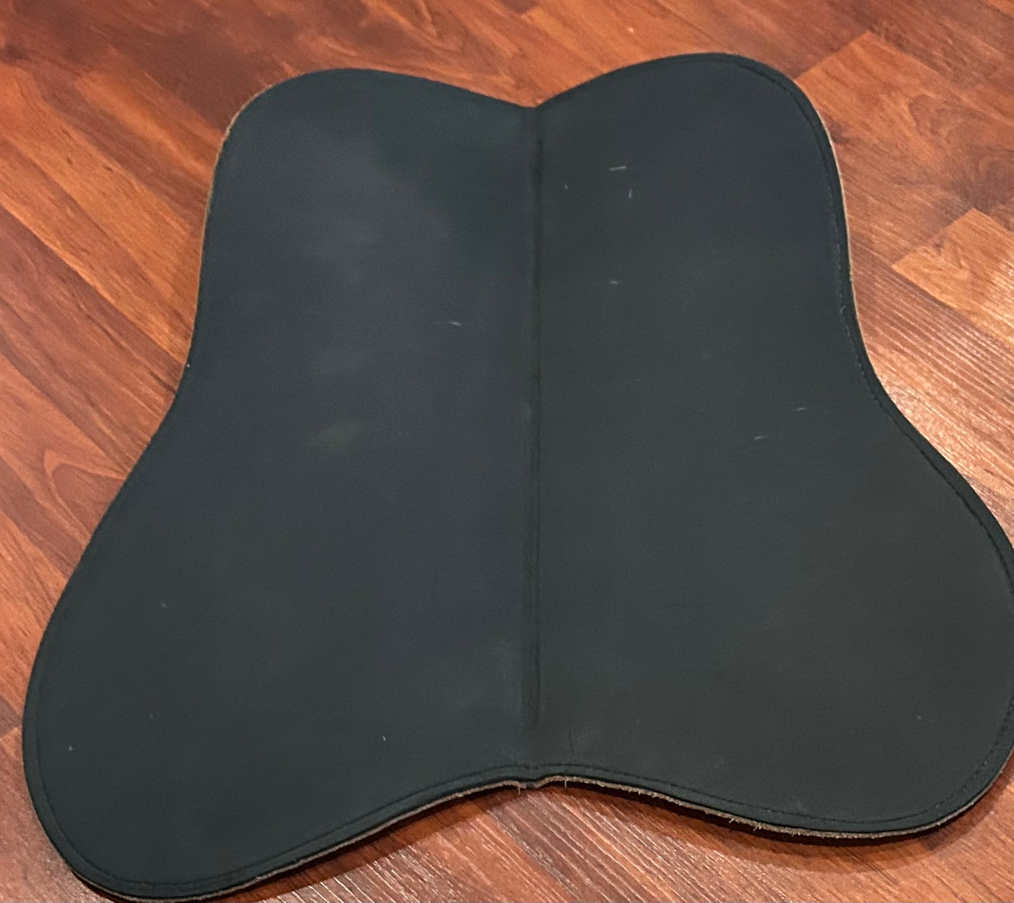 Tad Coffin leather half pad. Measures 19” along spine