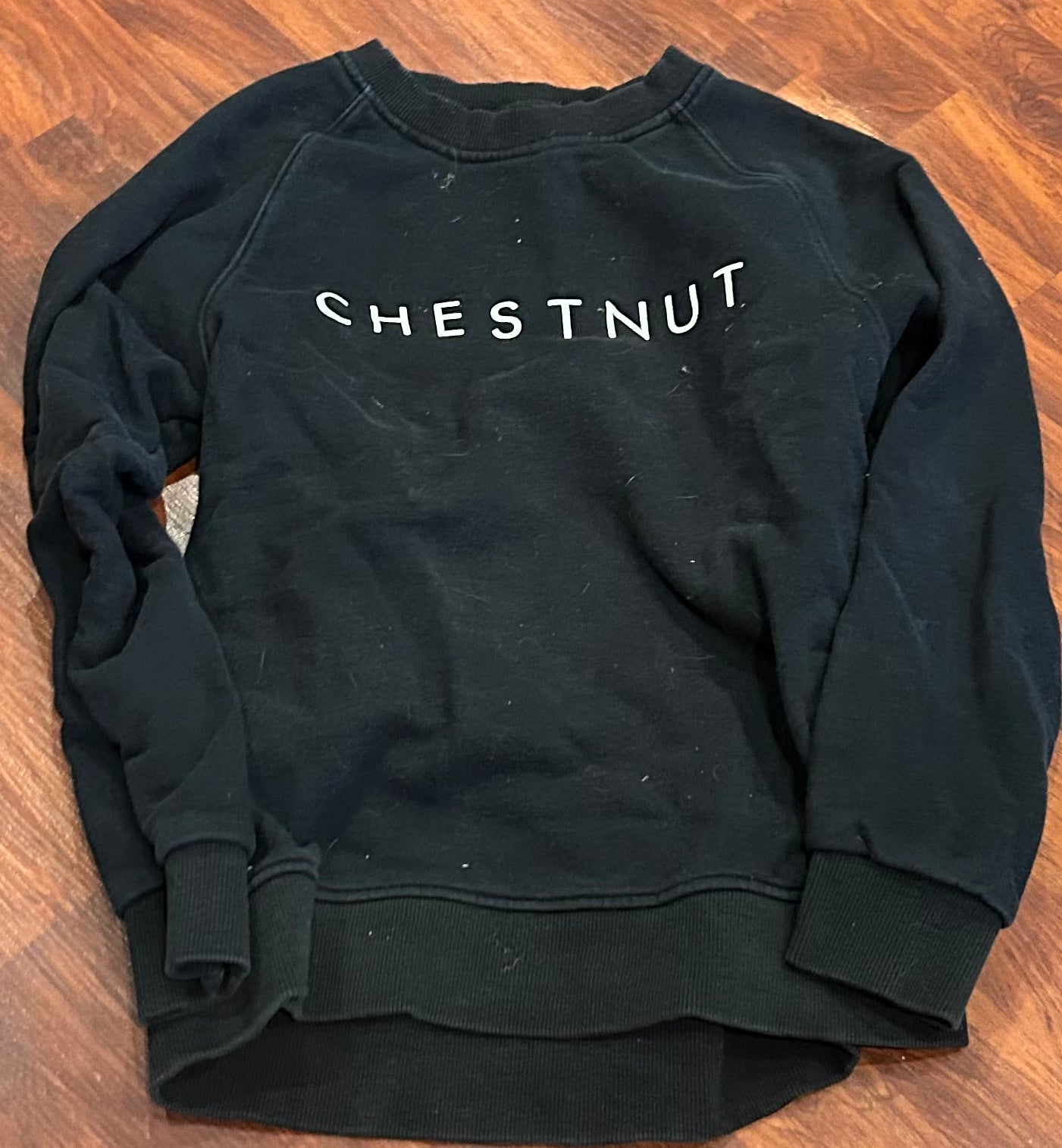 Black sweater small. Says “chestnut”