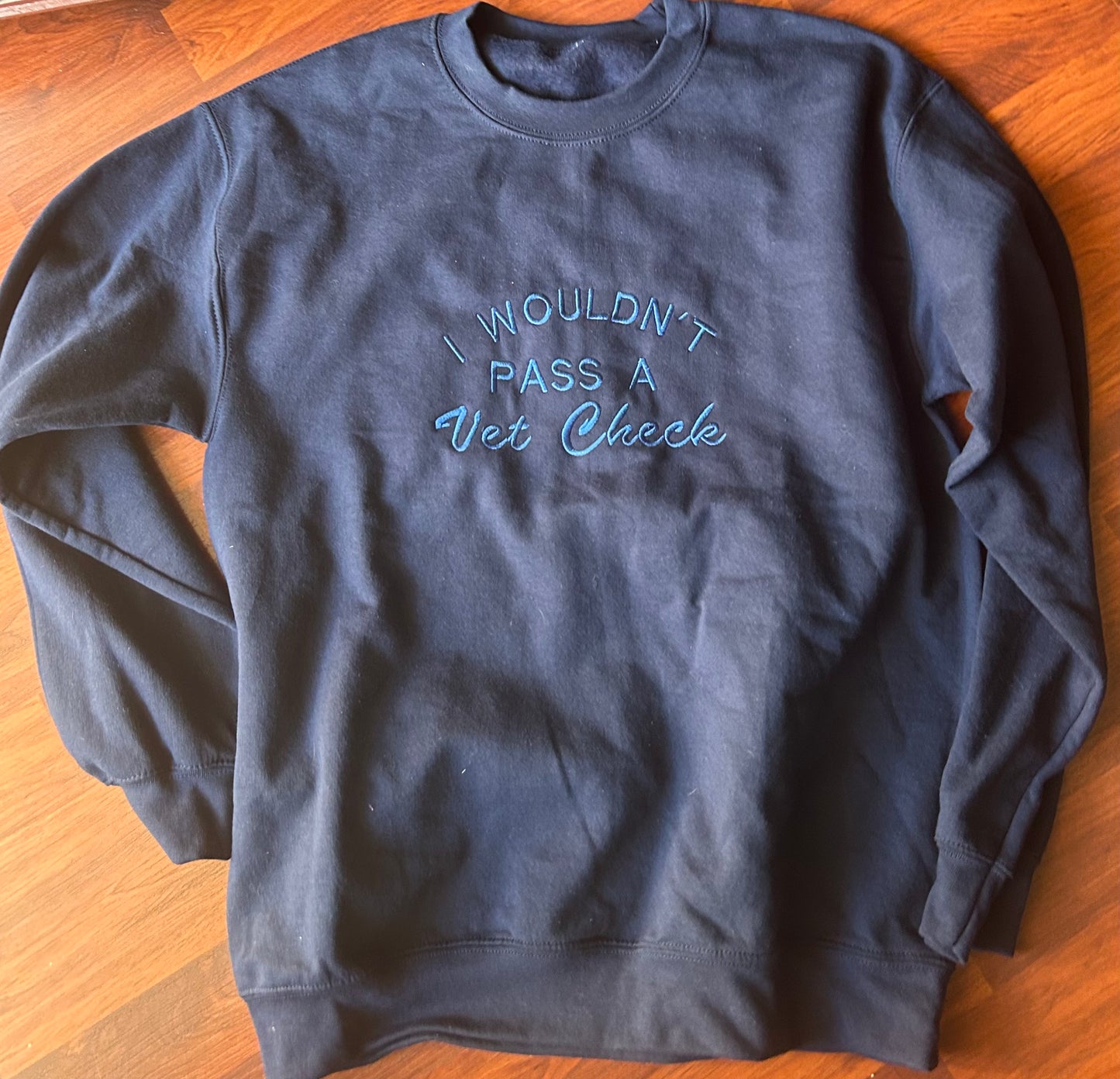 Medium wouldn’t pass a vet check blue sweater. Embroidered