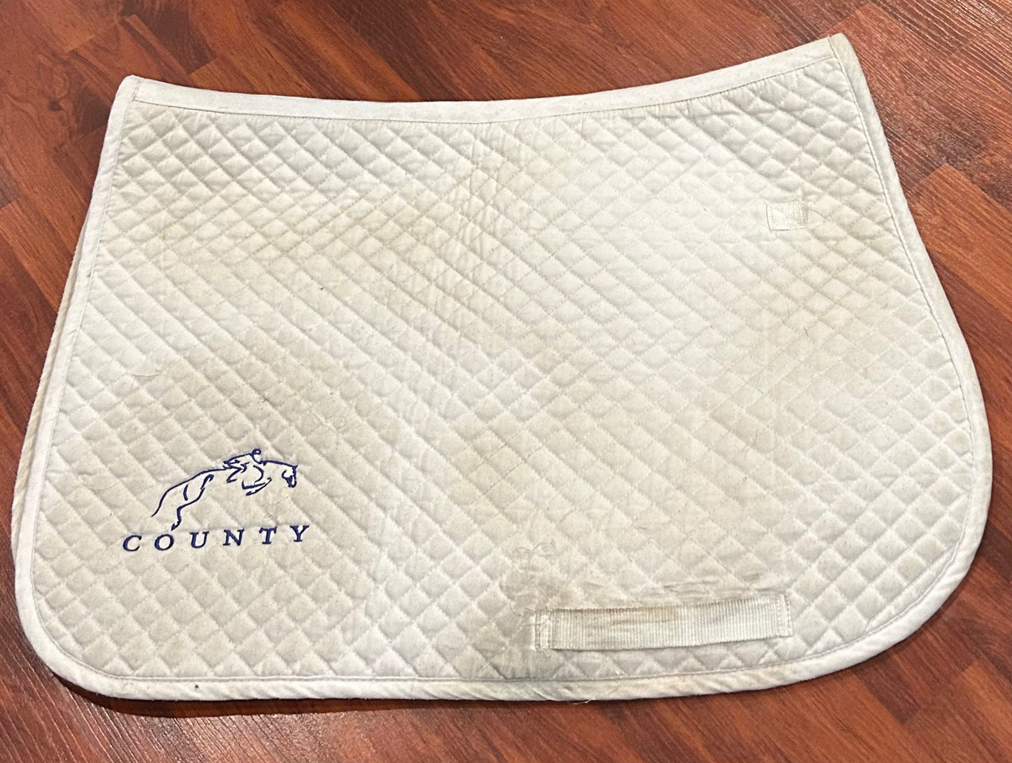 County embroidered white close contact pad. Dirty
