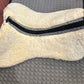 Mattes sheepskin Large black and natural dressage pad. Minor damage to sheepskin.