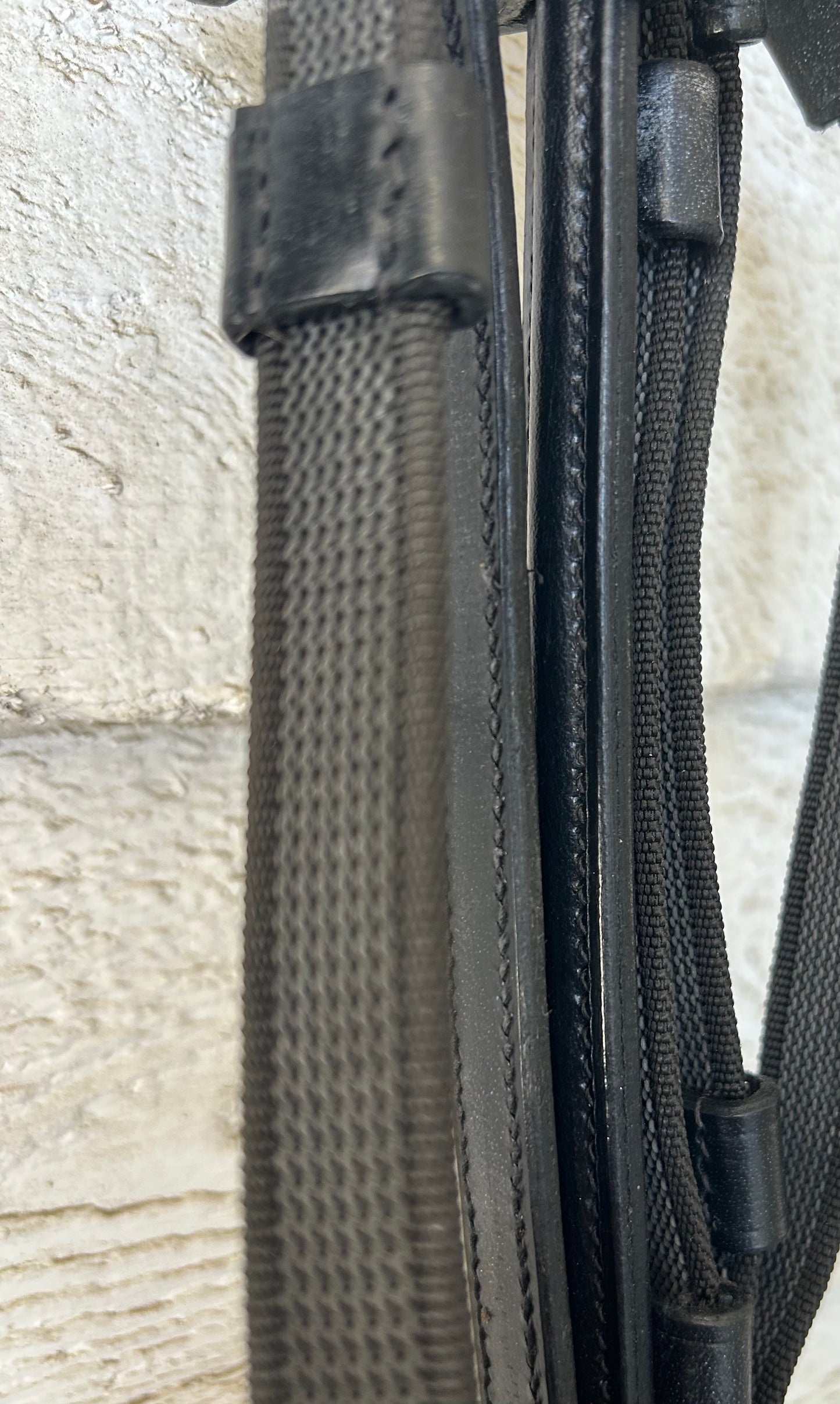 Black raised leather reins. Buckle closure. No slip thin rubber with hand stops