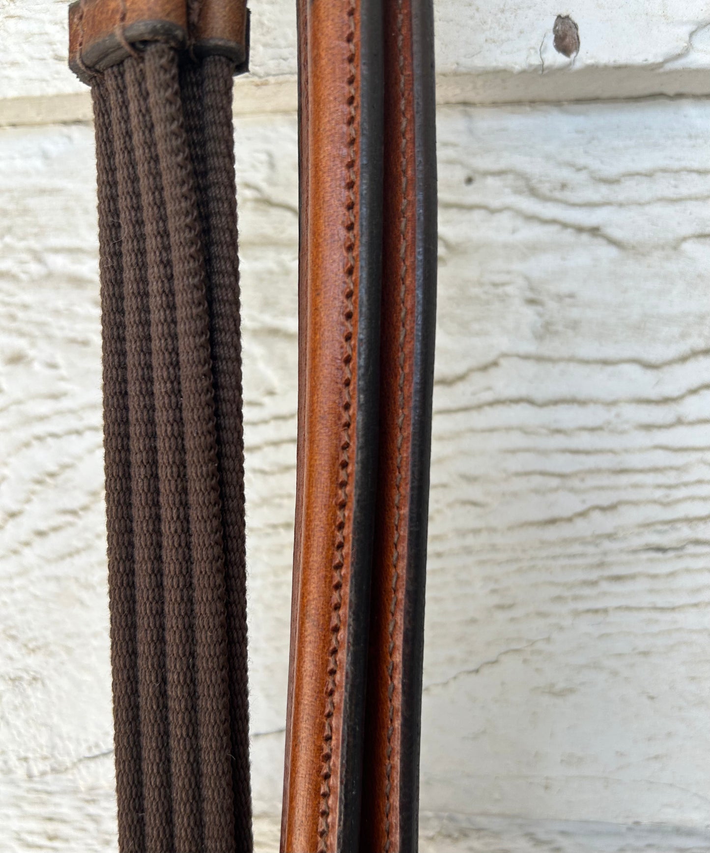 56” Havana raised leather reins nylon with hand stops. Brand new