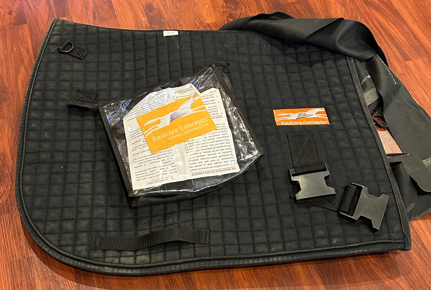 Equicore equiband. Used but good condition. Pad has hair on it. 2 sets of elastics bands.