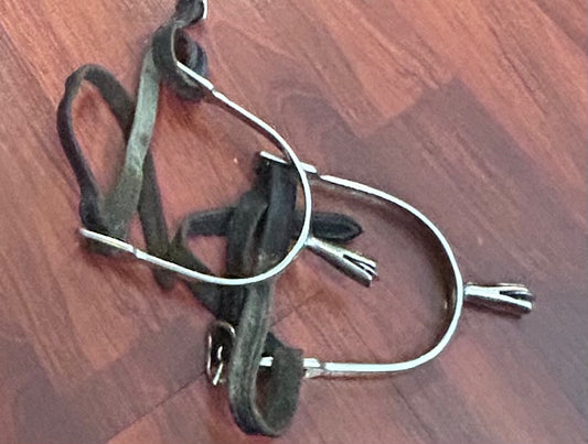 Smooth disk rowel spurs with older leather straps