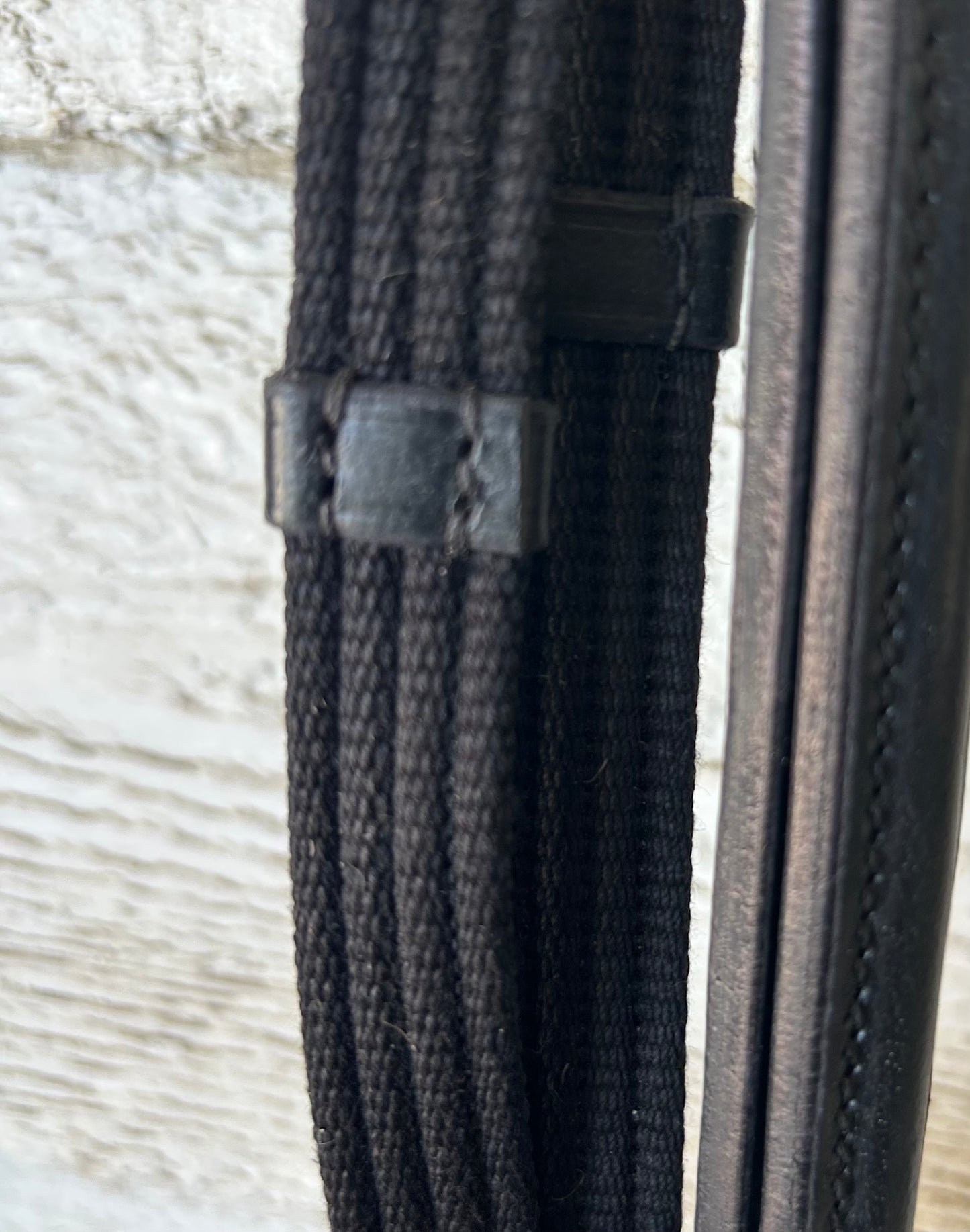 Black reins buckle closure, raised leather. Nylon with stops. Brand new