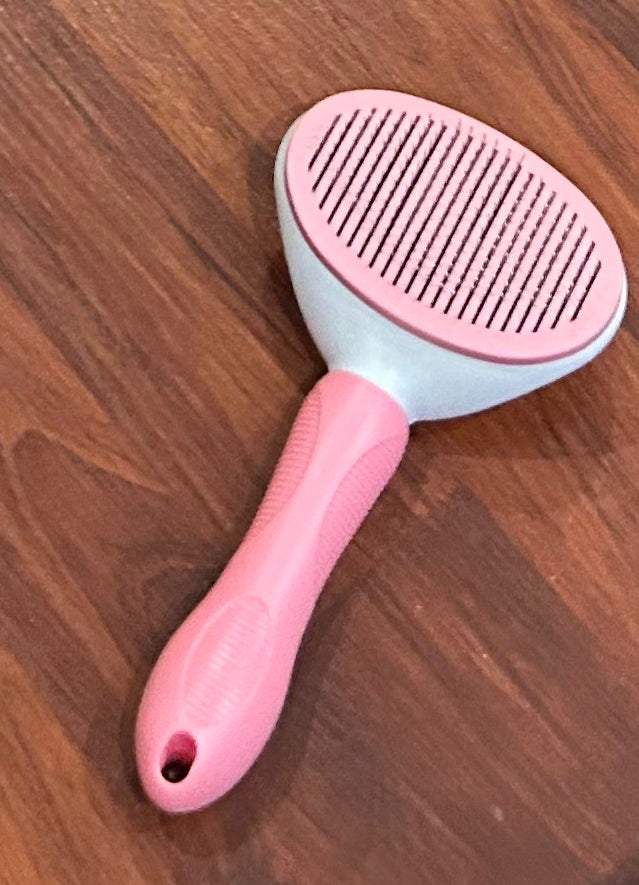 Self cleaning pet grooming brush pink