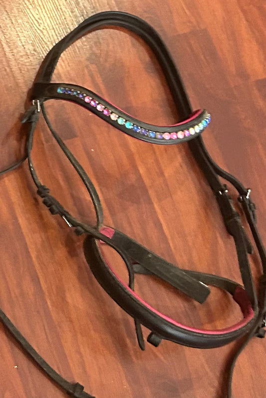 Cob size black/pink/rainbow bridle. No flash.