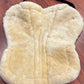 Fleeceworks sheepskin half pad. Saddle area measures 18” along spine. Minor dirt from use.