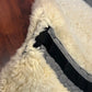 Mattes sheepskin Large black and natural dressage pad. Minor damage to sheepskin.