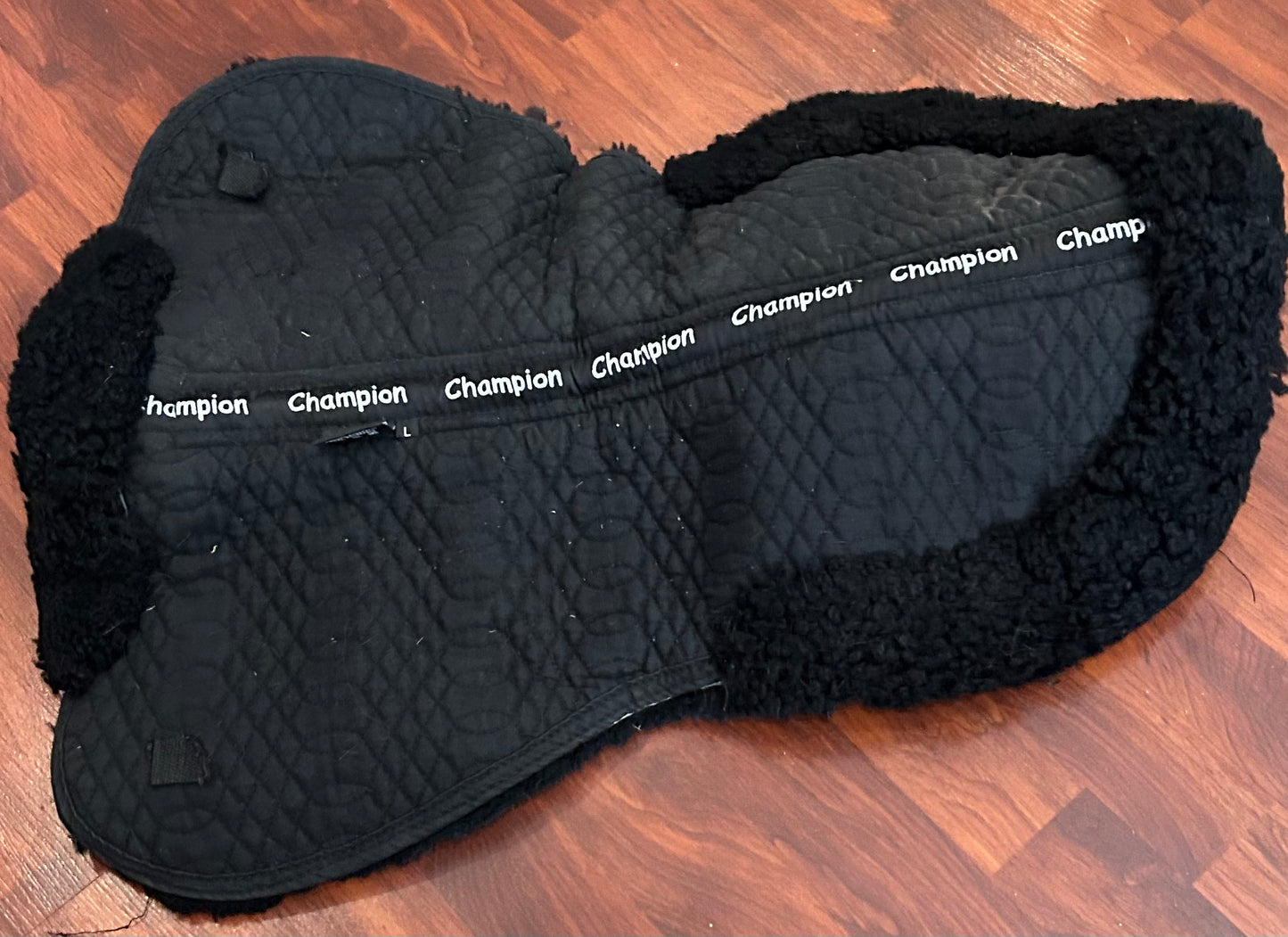Champion large black half pad. Thick. Sheepskin is discoloured but clean