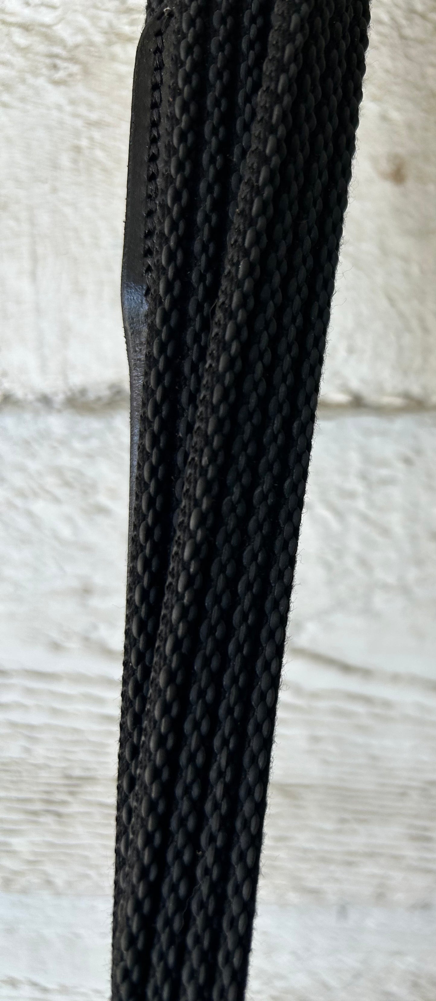 Black reins buckle closure. 56” raised with grippy  rubber.