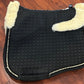 Mattes sheepskin Large black and natural dressage pad. Minor damage to sheepskin.