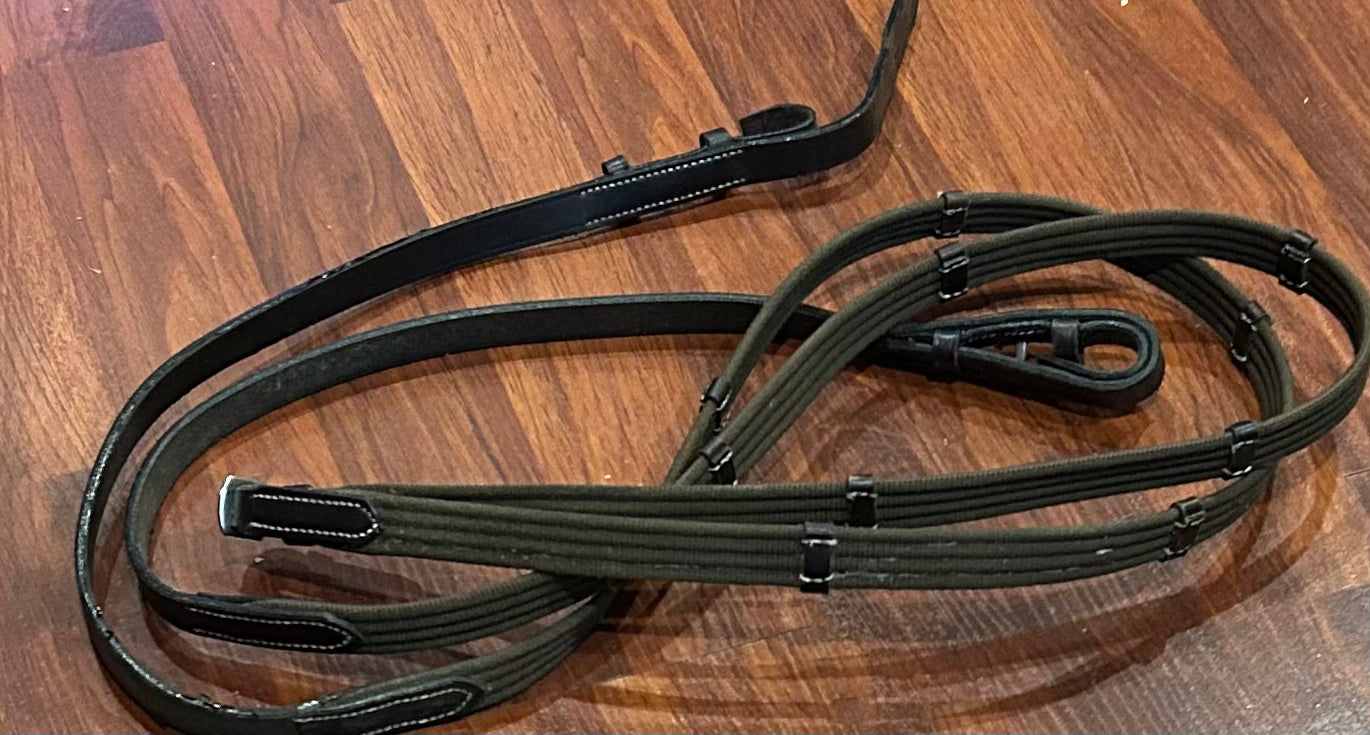 Brown nylon with hand stop reins. Not stamped. Good quality.