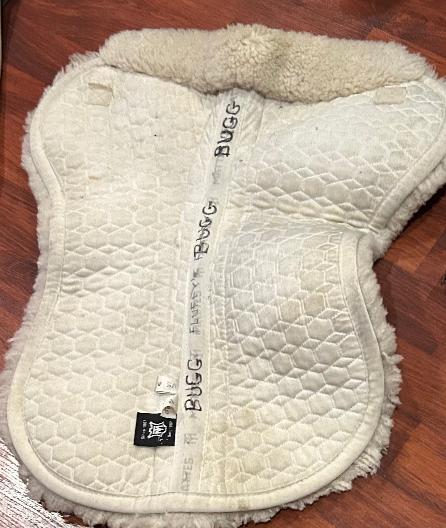 Mattes medium white half pad. Some damage to sheepskin