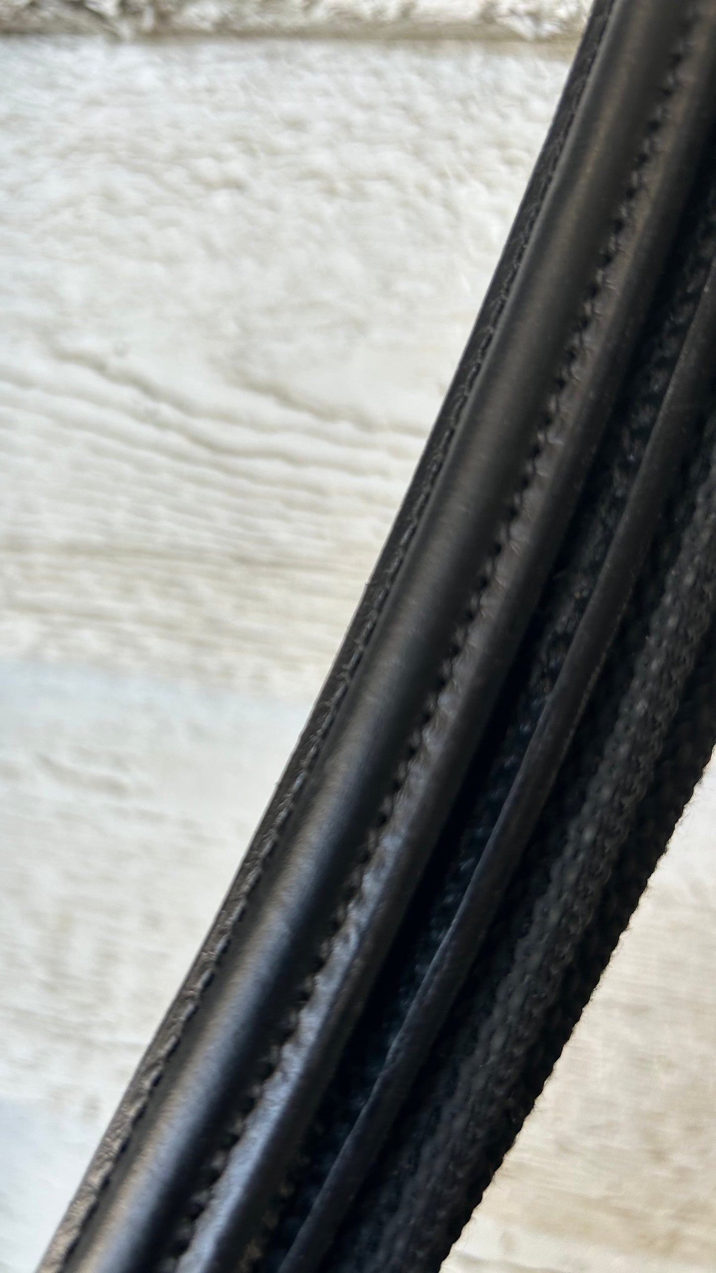 Black reins buckle closure. 56” raised with grippy  rubber.