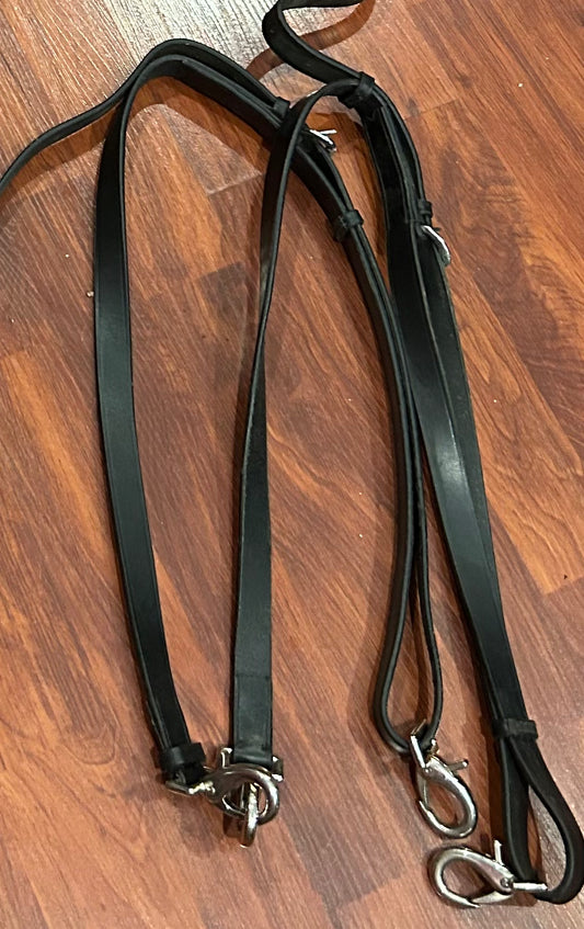 Leather side reins. Not branded but soft. No elastic.