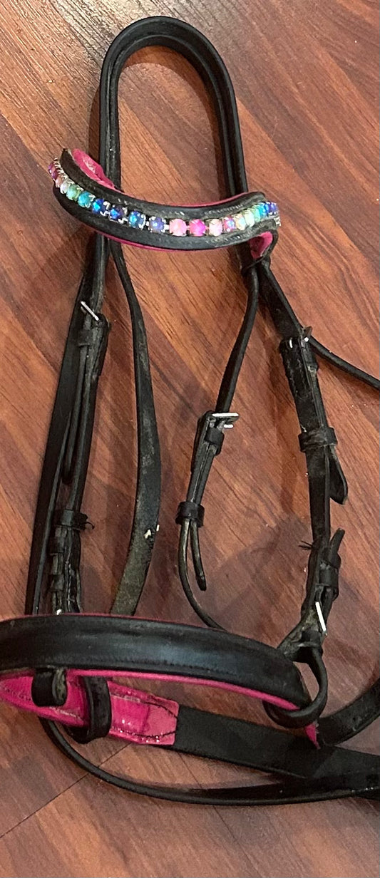 Cob size black/pink/rainbow bridle. No flash. Missing one stone