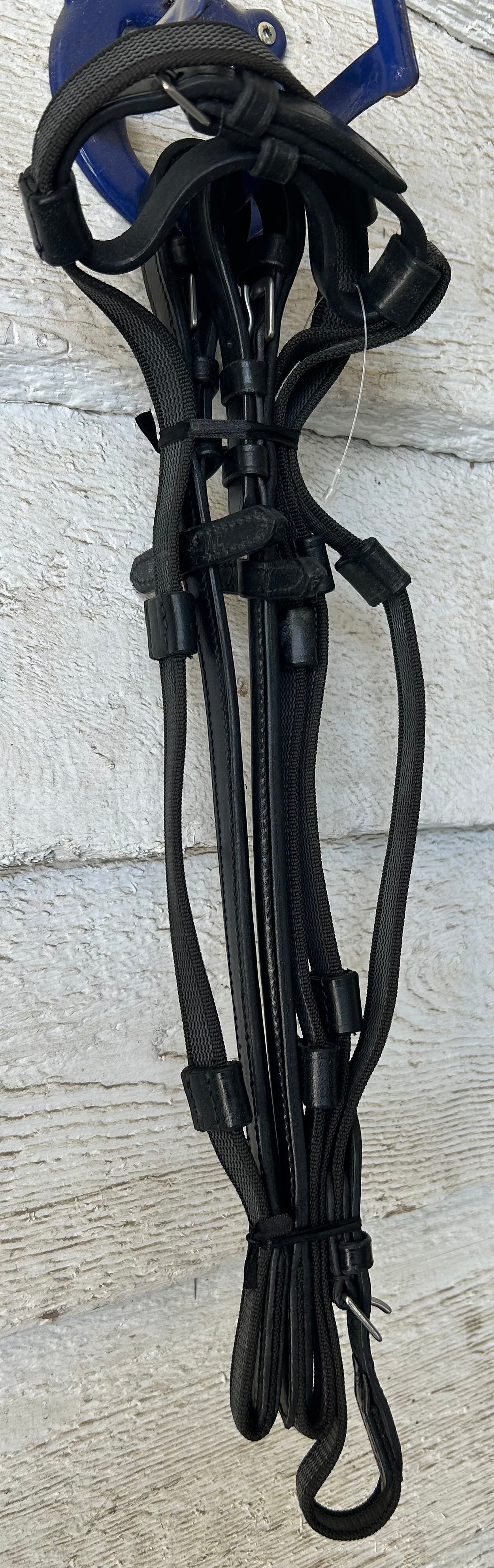 Black raised leather reins. Buckle closure. No slip thin rubber with hand stops