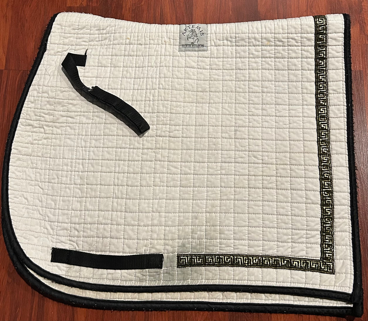 Artemis white with black and gold trim dressage pad