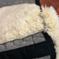Mattes sheepskin Large black and natural dressage pad. Minor damage to sheepskin.