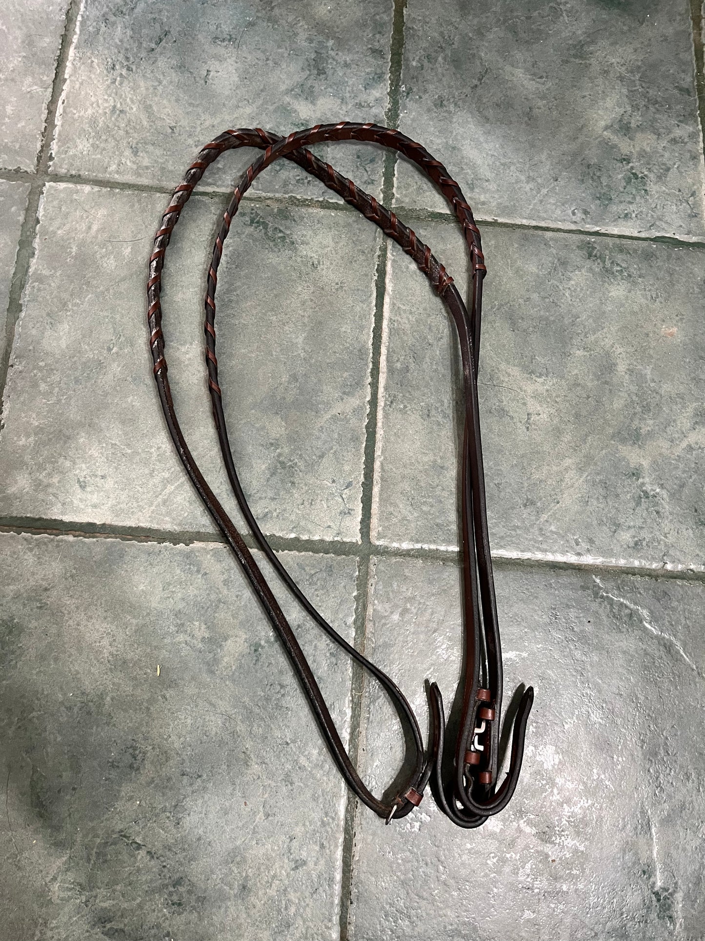 Braided brown leather reins