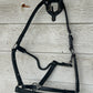 Full ride black leather halter with chrome hardware. Adjusts at chin. Clip. Has rivets on both cheek pieces. Brand new.